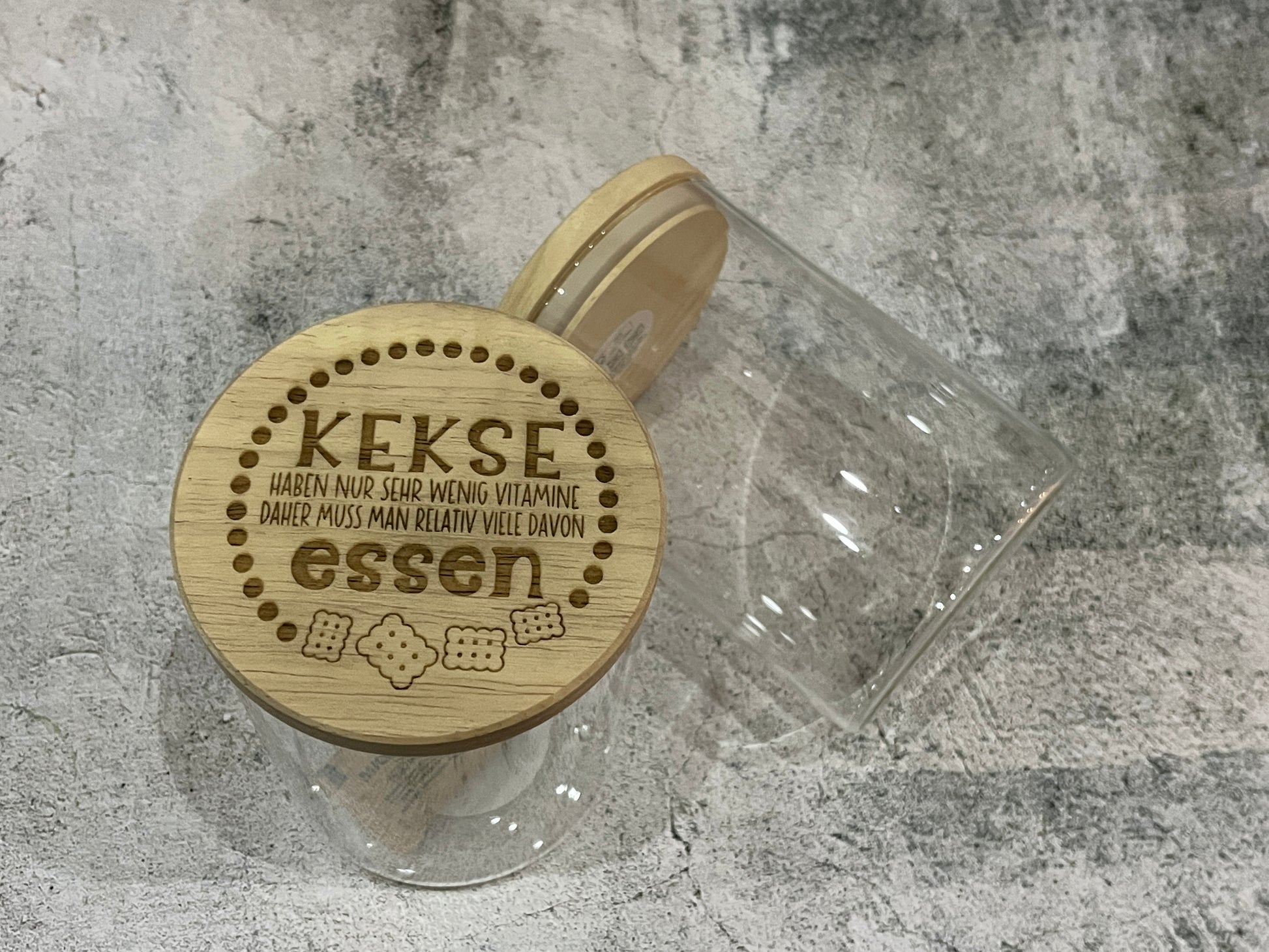 Vorratsglas aus durchsichtigem Glas mit Holzdeckel. Hier mit Gravur Kekse haben nur sehr wenig Vitamine. Daher muss man relativ viele davon essen.